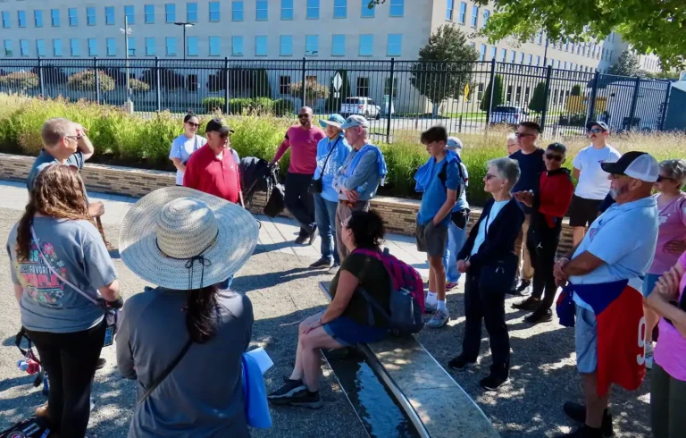 photo of a group of people assembling to talk about the events of 911 outside on a nice warm day