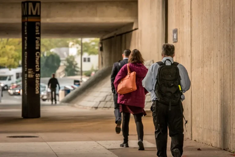 commuters heading off to the metro station under an overpass. Photo Credit: Sam Kittner/Kittner.com