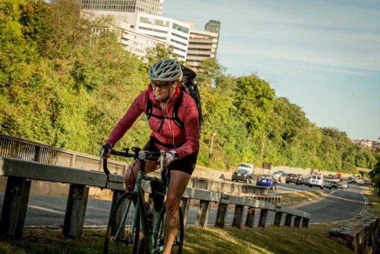 A person riding a bike uphill.
